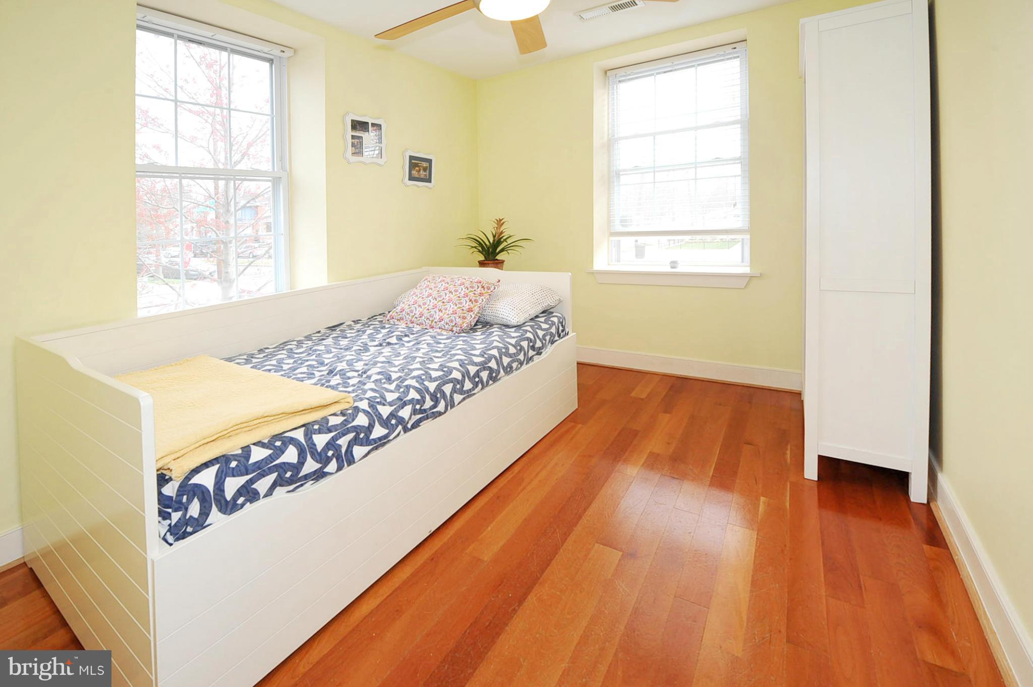 1400 Longfellow Street Northwest, Unit 101 Washington, DC 20011 - Photo 9 of 14 a bedroom with a bed and wooden floor