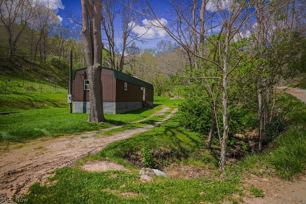 1547 Providence Road Elizabeth, WV 26143 - Photo 21 of 32 Brown siding structure with a green metal roof and concrete block foundation