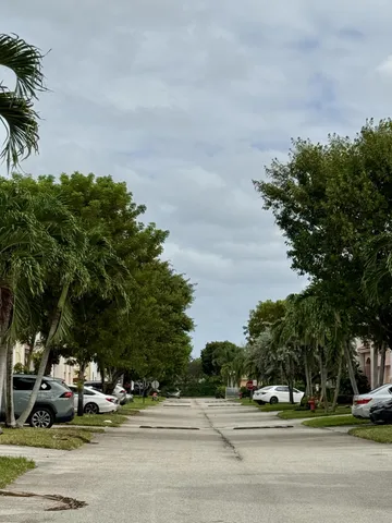 a view of a cars parked on the side of a street