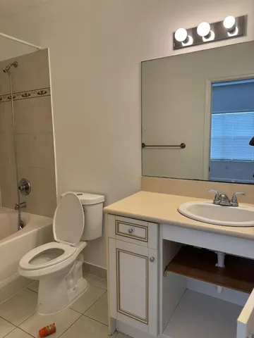 a bathroom with a sink a toilet and mirror
