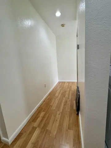 a view of hallway with wooden floor