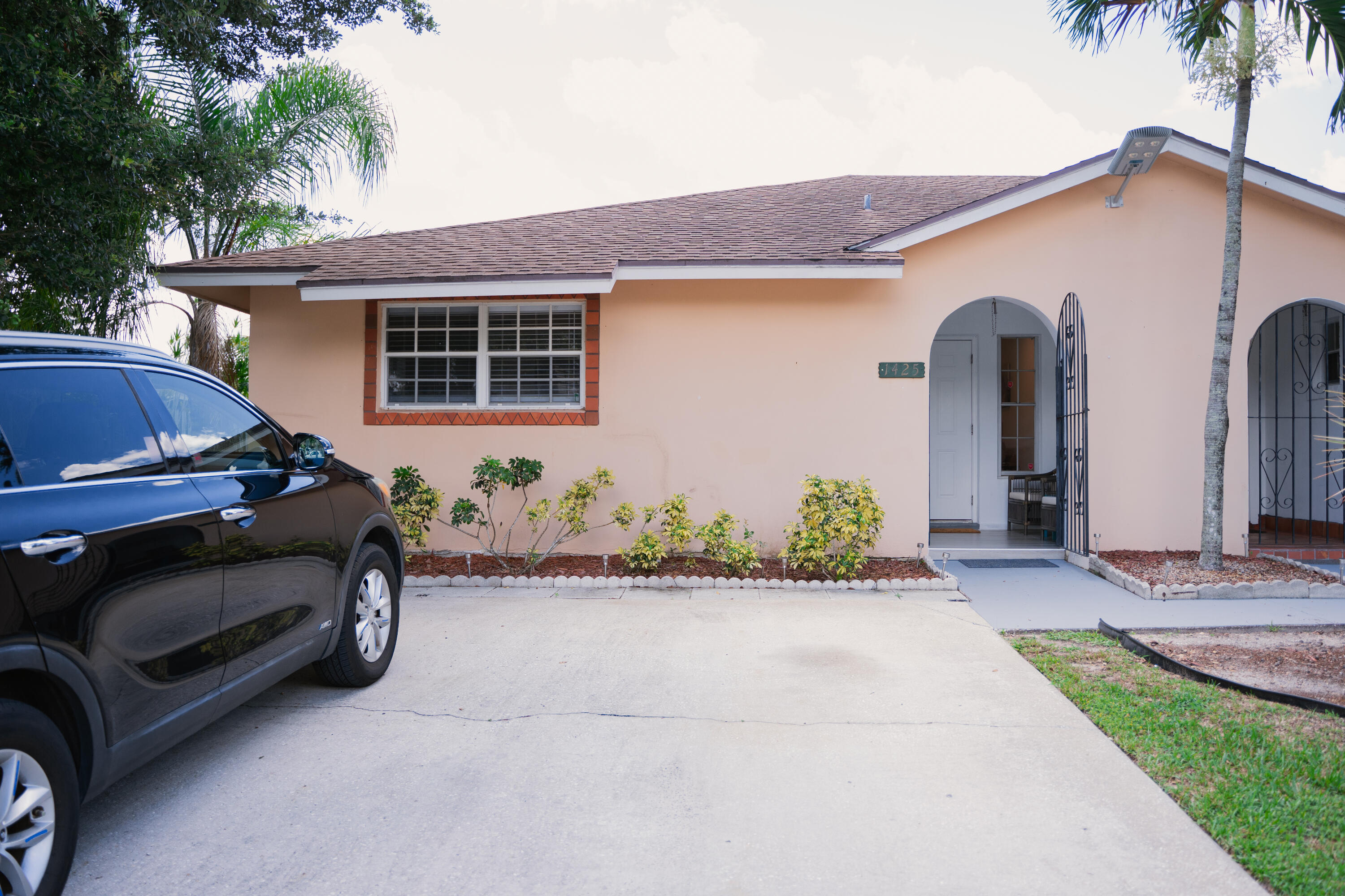 1425 Riverside Circle Wellington, FL 33414 - Photo 1 of 35 a front view of a house with garden