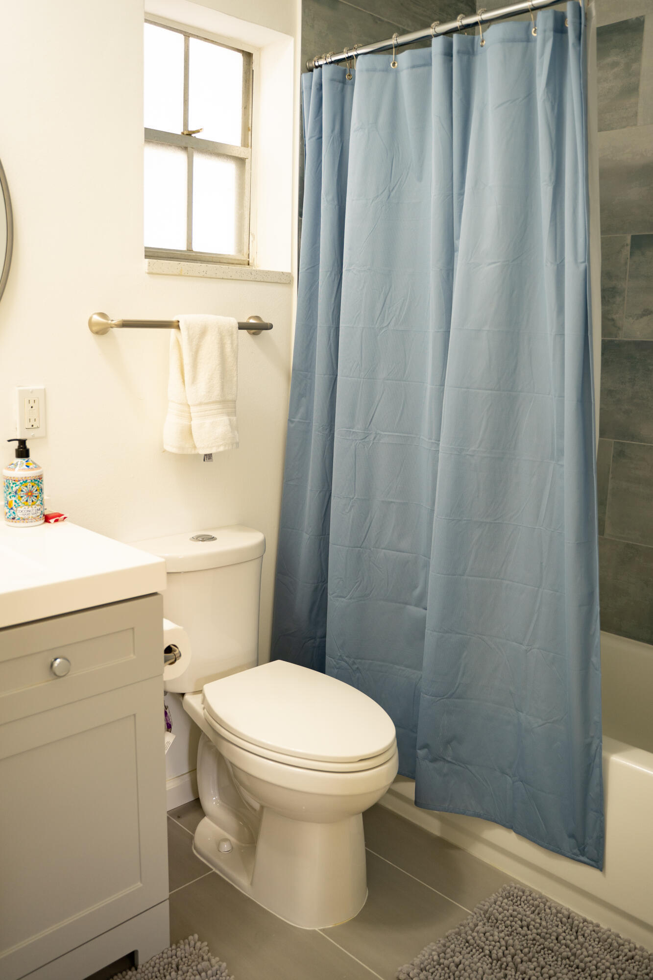 1425 Riverside Circle Wellington, FL 33414 - Photo 18 of 35 a white toilet sitting next to a bathroom sink and vanity