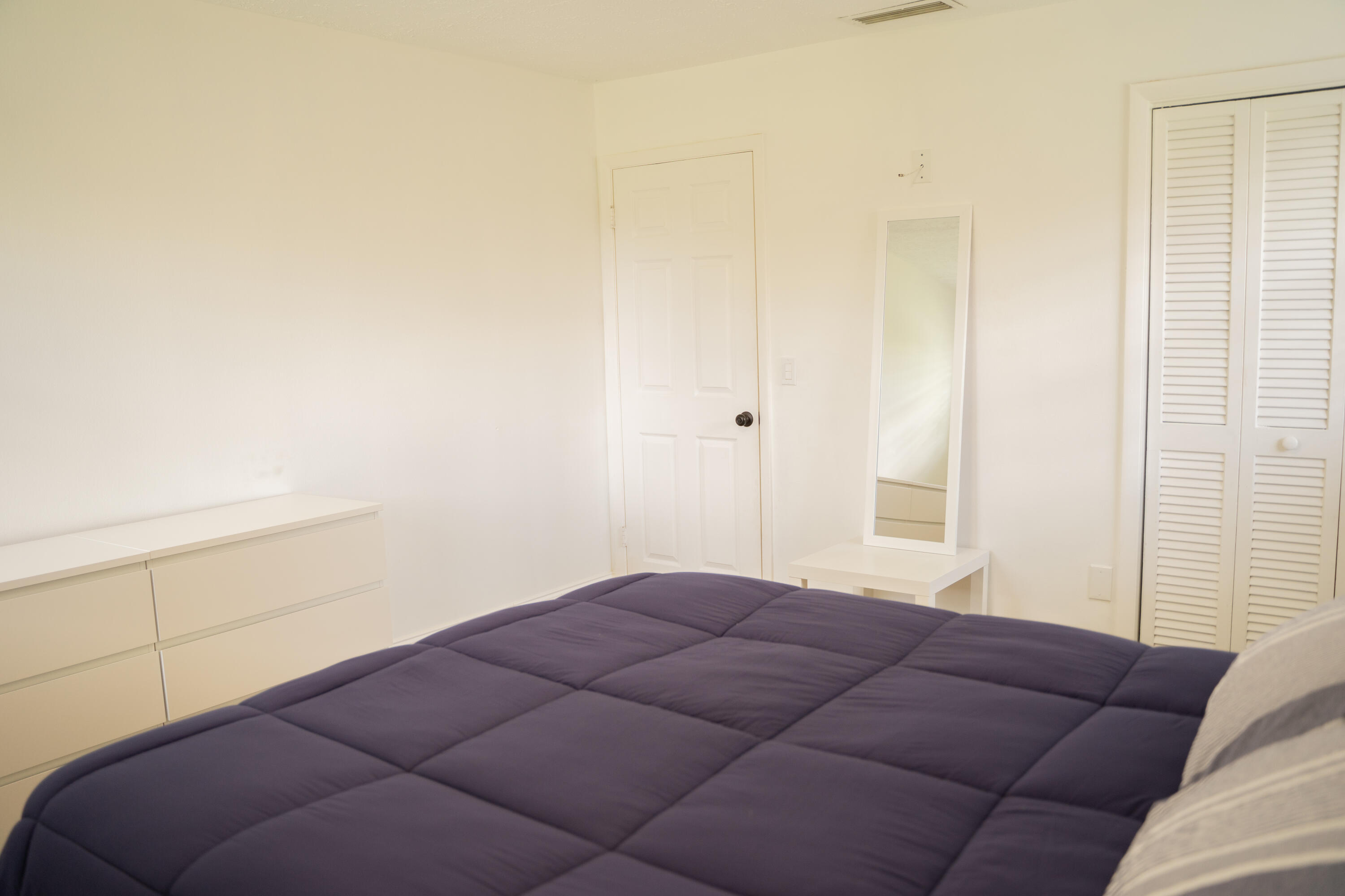 1425 Riverside Circle Wellington, FL 33414 - Photo 19 of 35 a bedroom with a bed and a window