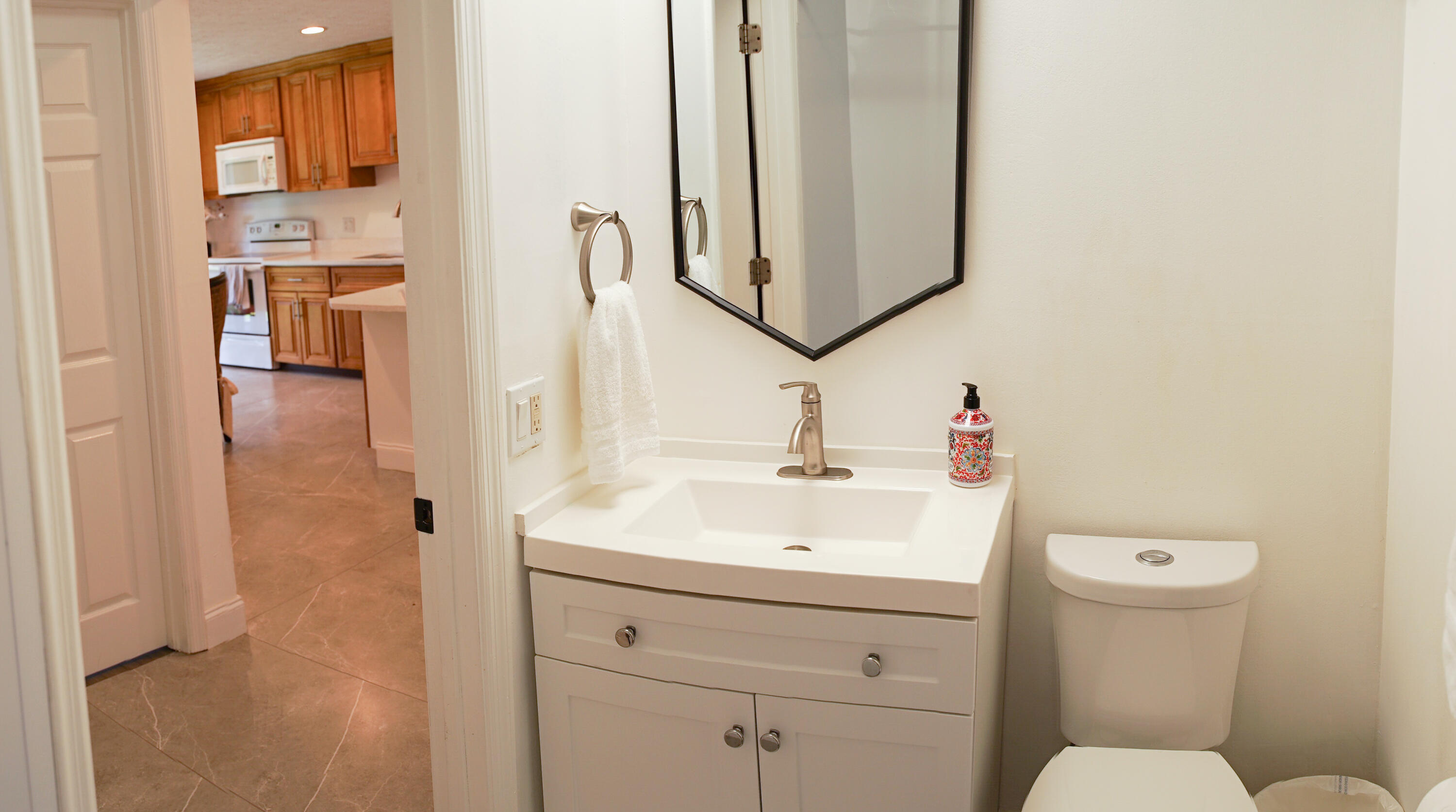 1425 Riverside Circle Wellington, FL 33414 - Photo 22 of 35 a bathroom with a toilet sink and mirror