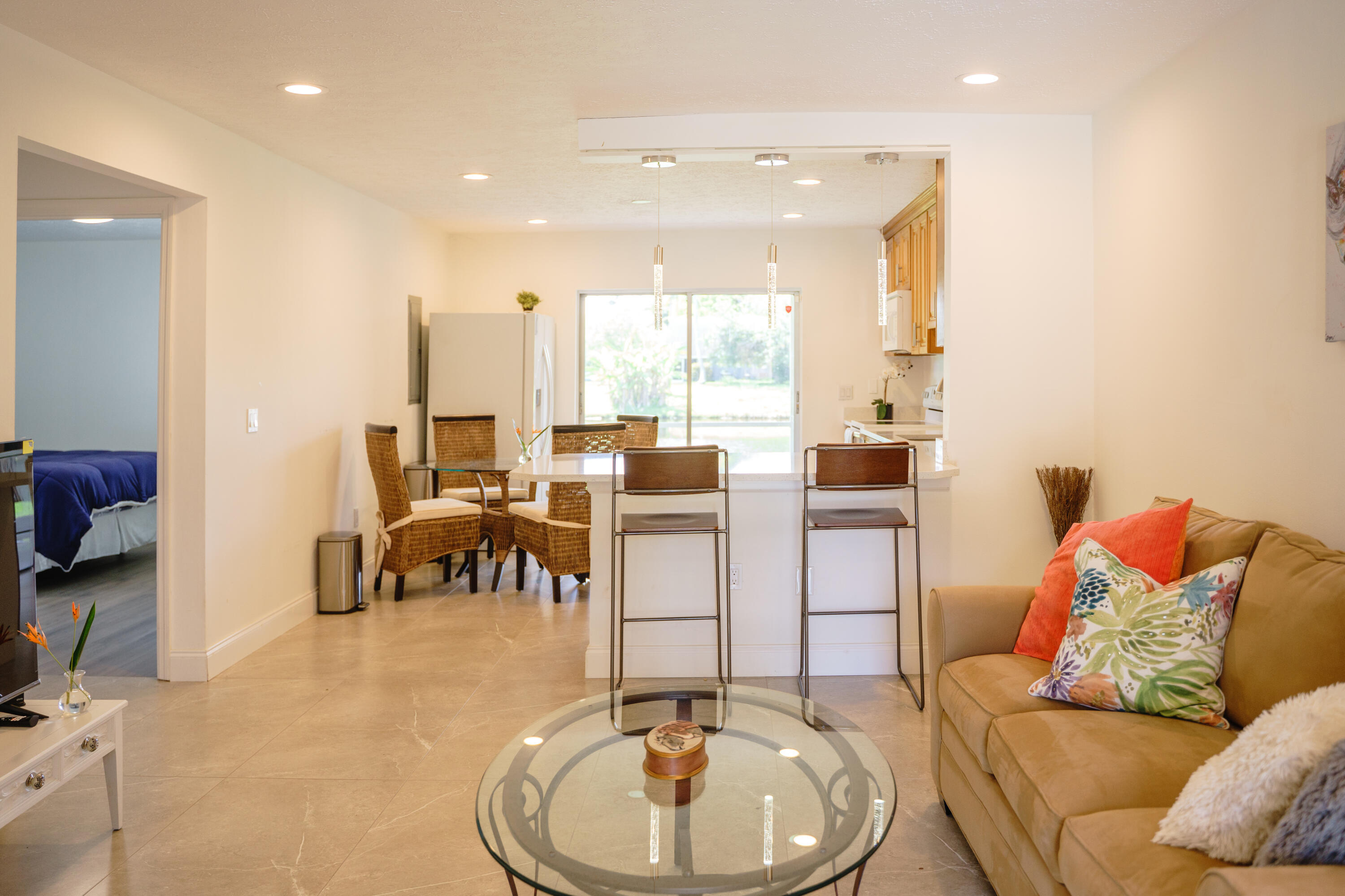 1425 Riverside Circle Wellington, FL 33414 - Photo 34 of 35 a living room with furniture and a dining table with kitchen view