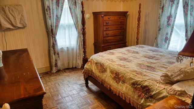 a spacious bedroom with a bed and a mirror