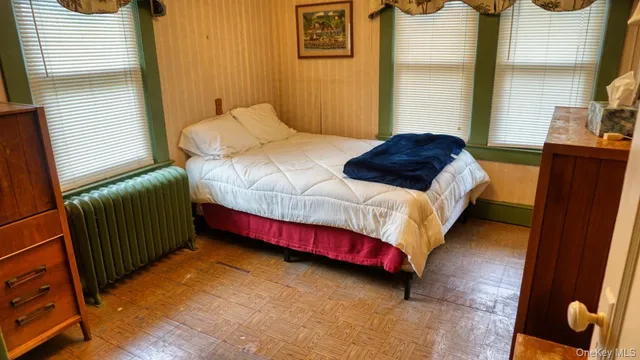a bedroom with a bed and dresser