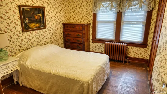 a bedroom with a bed and dresser