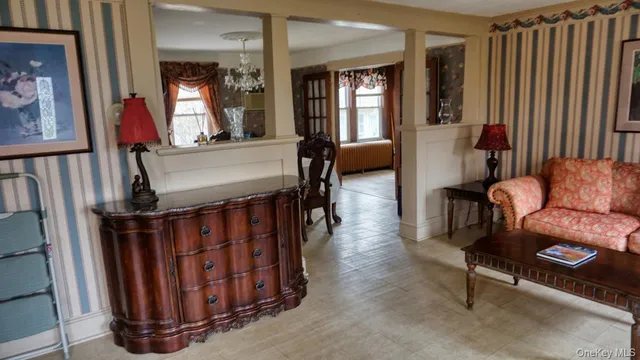 a living room with furniture stairs and a window