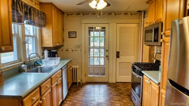 a kitchen with granite countertop a sink and a refrigerator