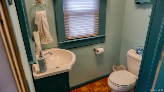 a bathroom with a toilet sink and mirror