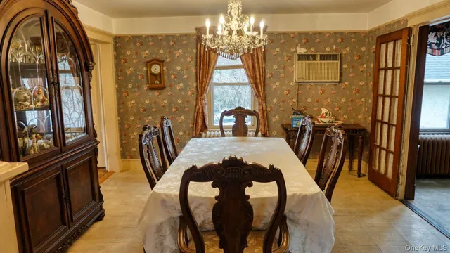 a view of a dining room with furniture and a chandelier