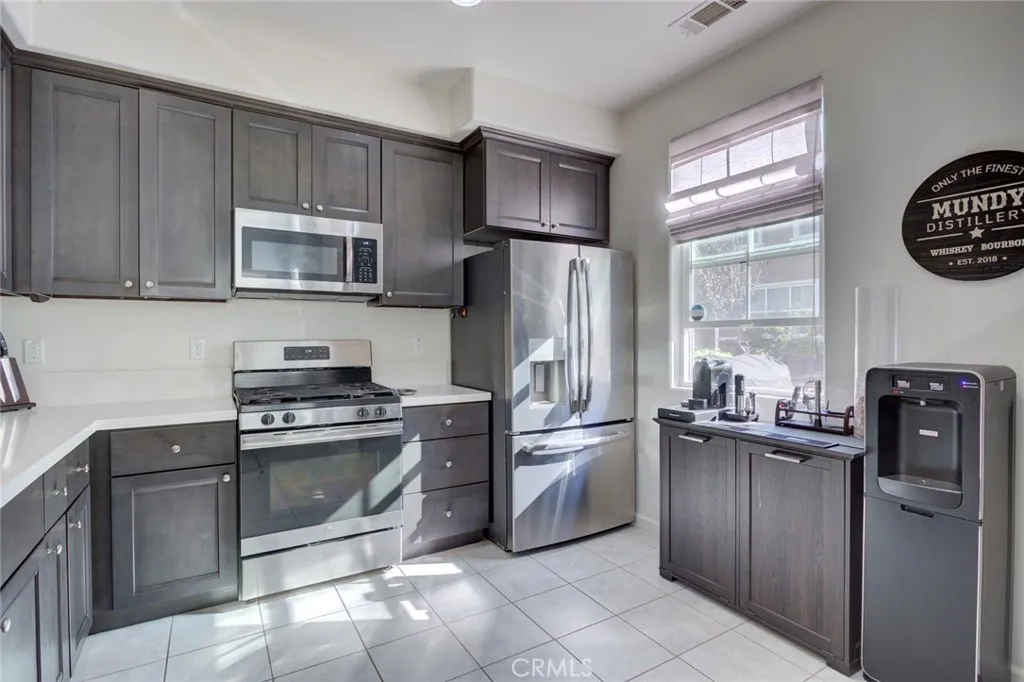1913 Celebration Avenue Santa Maria, CA 93454 - Photo 14 of 35 a kitchen with stainless steel appliances granite countertop a refrigerator stove and microwave