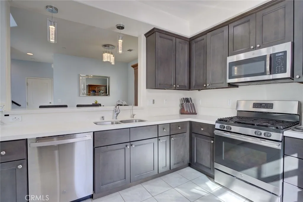 1913 Celebration Avenue Santa Maria, CA 93454 - Photo 15 of 35 a kitchen with a sink stove and microwave