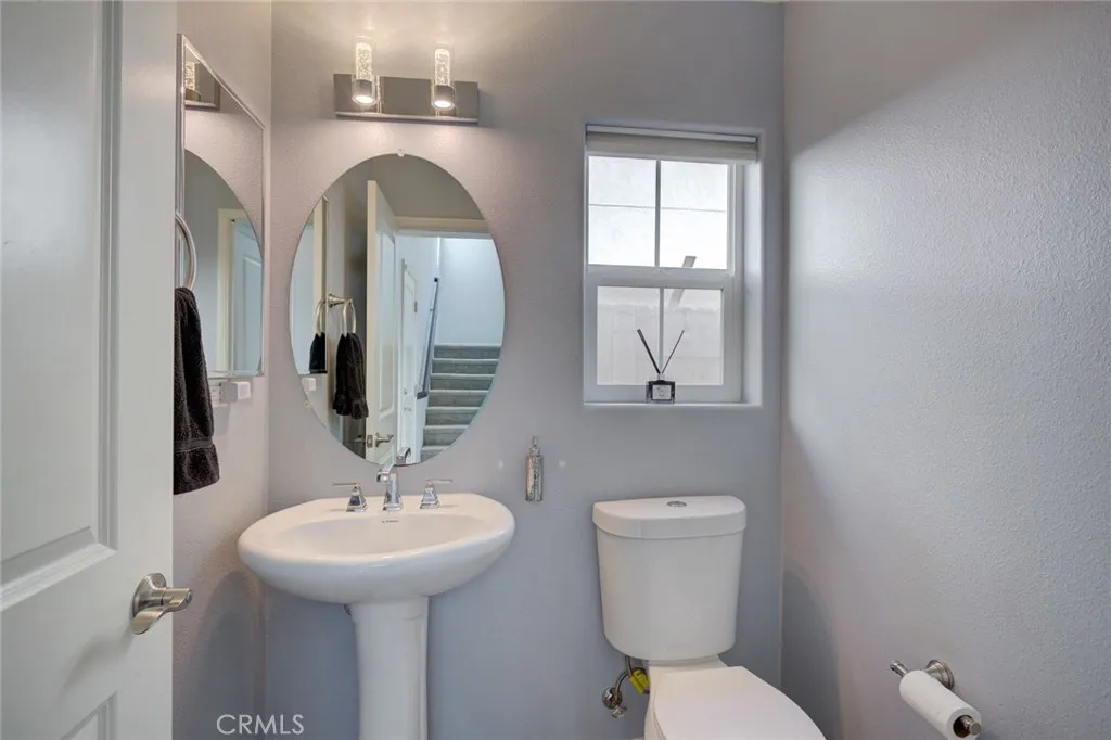 1913 Celebration Avenue Santa Maria, CA 93454 - Photo 20 of 35 a bathroom with a toilet sink and mirror