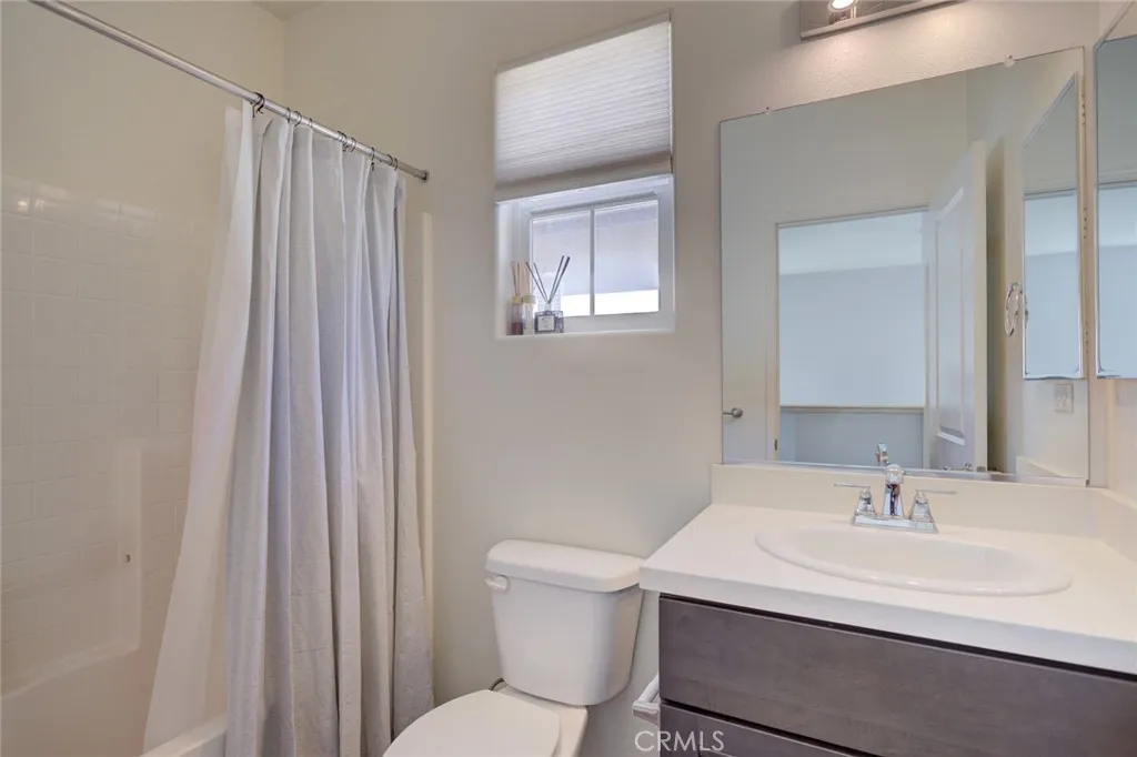1913 Celebration Avenue Santa Maria, CA 93454 - Photo 25 of 35 a bathroom with a sink a toilet and shower curtain