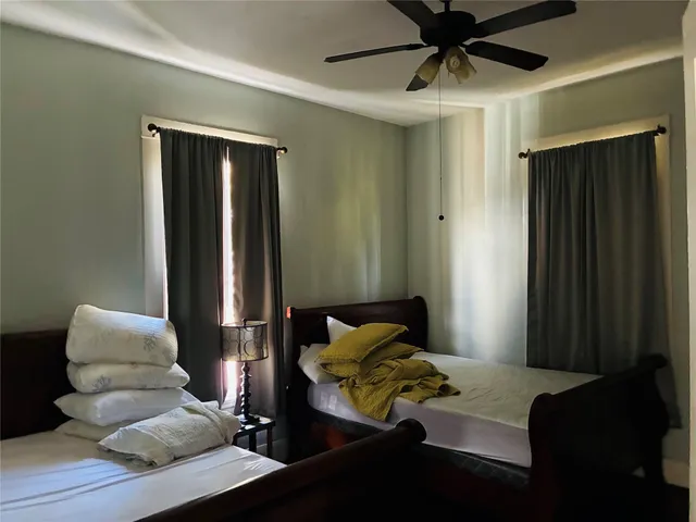 a bedroom with furniture and a window