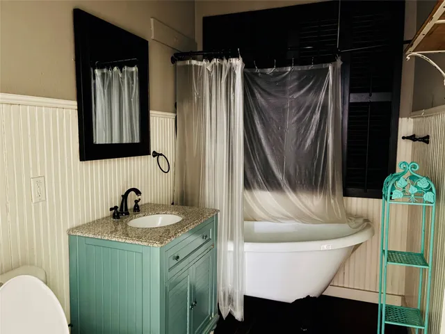 a bathroom with a sink toilet and shower