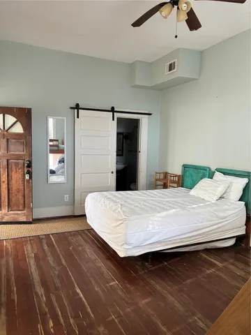 a bedroom with a bed and a dresser