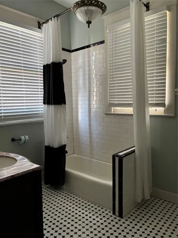 a bathroom with a bathtub and a shower