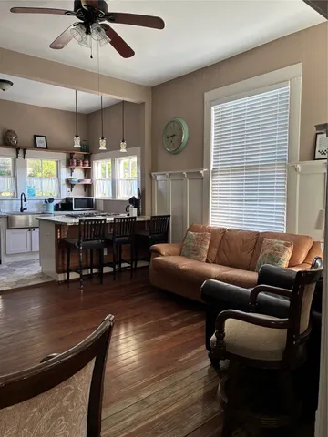 a living room with furniture and wooden floor