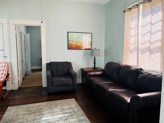 a living room with furniture and a rug