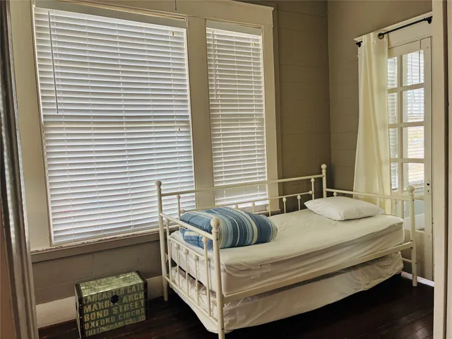 a bedroom with furniture and a window