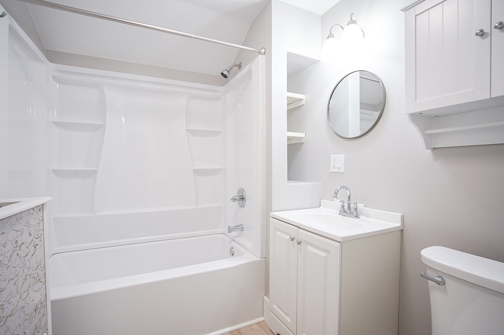 42 Montgomery Street, Unit 42 Westfield, MA 01085 - Photo 11 of 14 a bathroom with a sink a toilet and a mirror