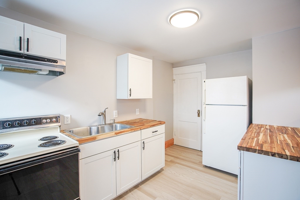 42 Montgomery Street, Unit 42 Westfield, MA 01085 - Photo 2 of 14 a kitchen with a sink a stove and a refrigerator