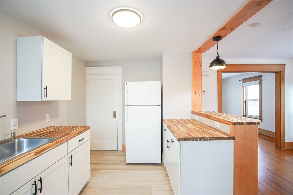 42 Montgomery Street, Unit 42 Westfield, MA 01085 - Photo 9 of 14 a kitchen with a refrigerator sink stove and cabinets