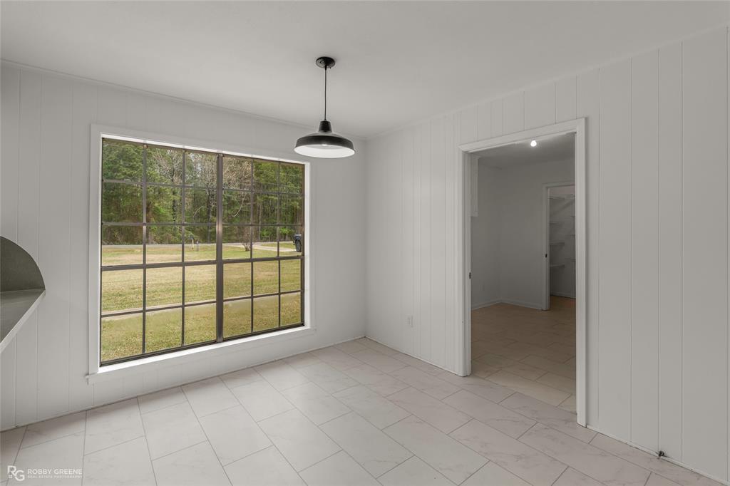 1303 Young Road Benton, LA 71006 - Photo 15 of 34 Unfurnished dining area with wood walls