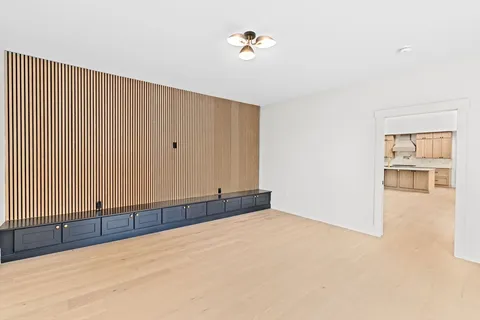 a view of an empty room with a painting on the wall