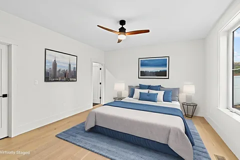 a spacious bedroom with a bed and a window