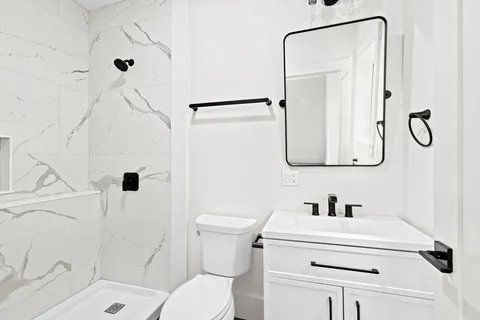 a view of an empty room with a painting on the wall