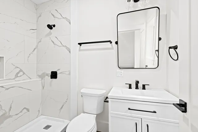 a bathroom with a double vanity sink a mirror a bathtub and shower