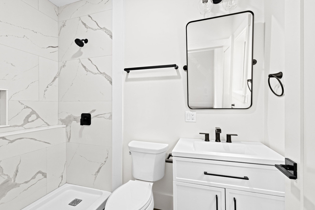 7 Lewis Court Hingham, MA 02043 - Photo 19 of 42 a bathroom with a sink a toilet and shower