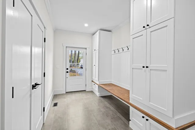 a view of an empty room with glass door and balcony