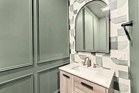 a kitchen with a sink stove and cabinets