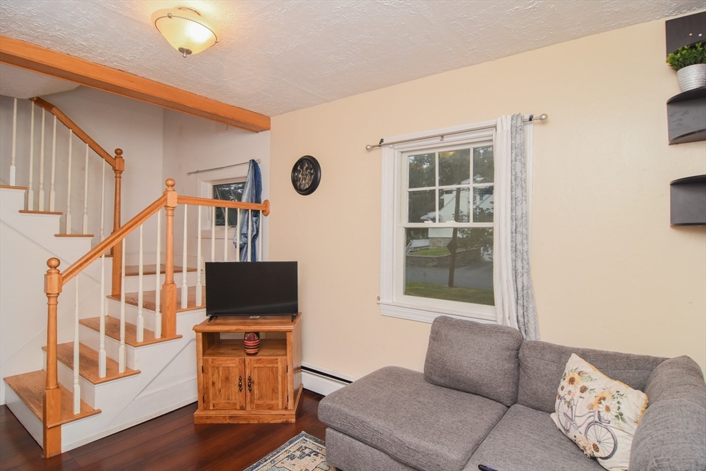 9 Topping Road Andover, MA 01810 - Photo 13 of 41 a living room with furniture and a flat screen tv