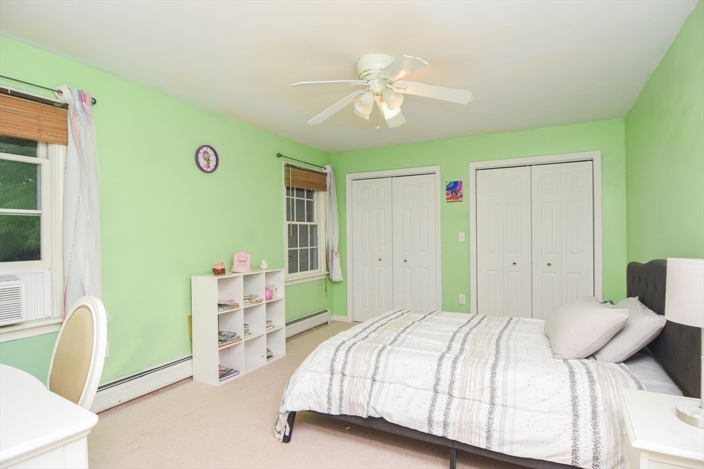 9 Topping Road Andover, MA 01810 - Photo 29 of 41 a bedroom with a bed and a chandelier