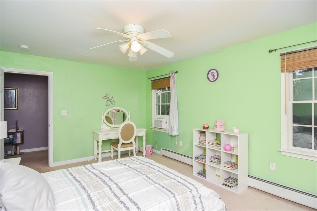 9 Topping Road Andover, MA 01810 - Photo 30 of 41 a bedroom with a bed and a chandelier