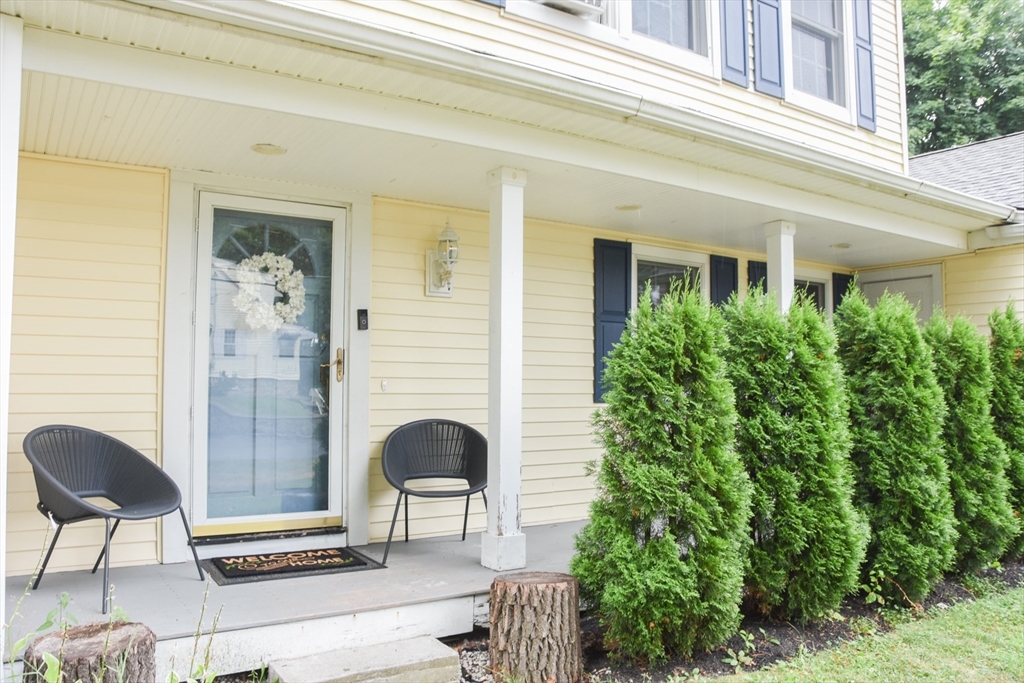 9 Topping Road Andover, MA 01810 - Photo 5 of 41 a front view of a house with outdoor seating and plants
