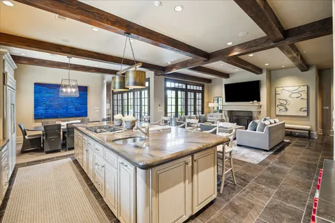 a view of kitchen island a sink a counter top space and living room