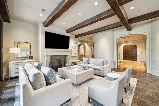 a living room with fireplace furniture and a flat screen tv