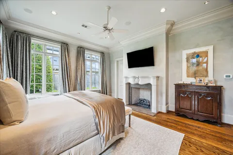 a spacious bedroom with a bed and a flat screen tv