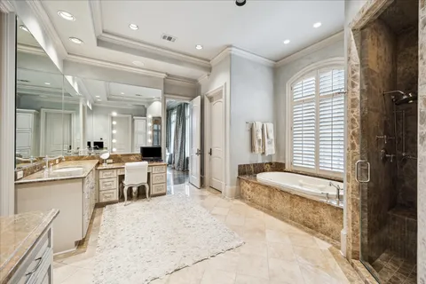 a large bathroom with a large tub and sink
