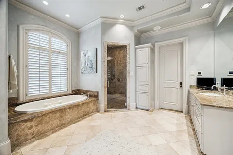 a spacious bathroom with a tub sink and shower