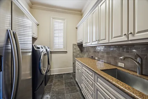 a view of a kitchen with a sink and washing machine