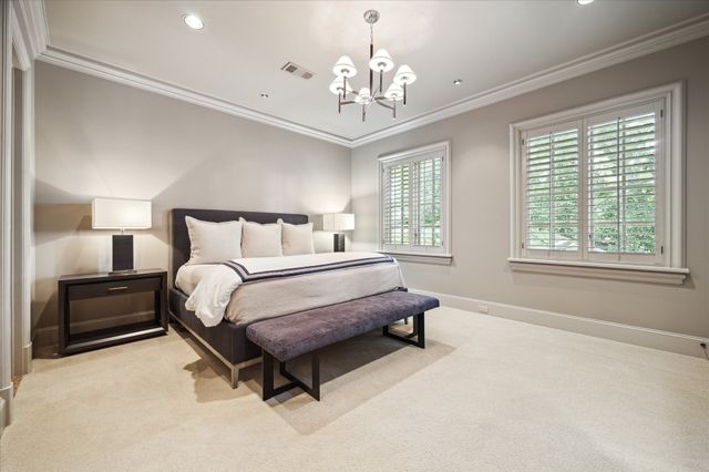 a spacious bedroom with a bed and a large window